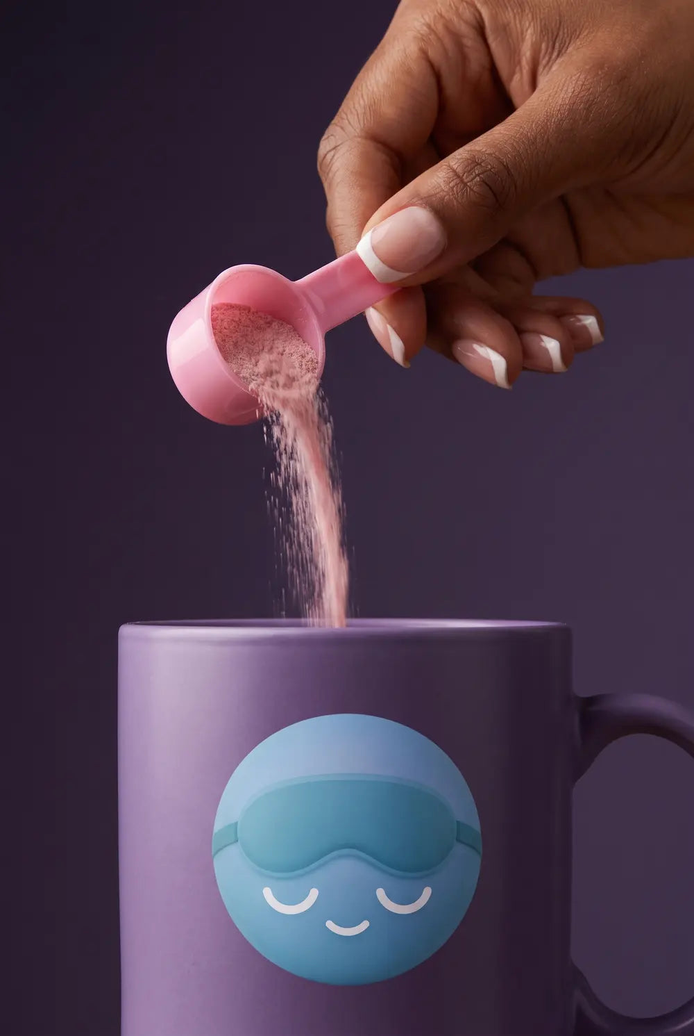 A scoop of tart cherry powder poured into a purple Dozy mug